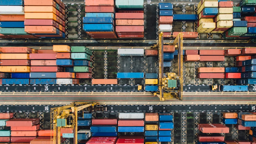 Aerial photo of containers. Photo by CHUTTERSNAP on Unsplash https://unsplash.com/photos/aerial-photo-of-pile-of-enclose-trailer-kyCNGGKCvyw